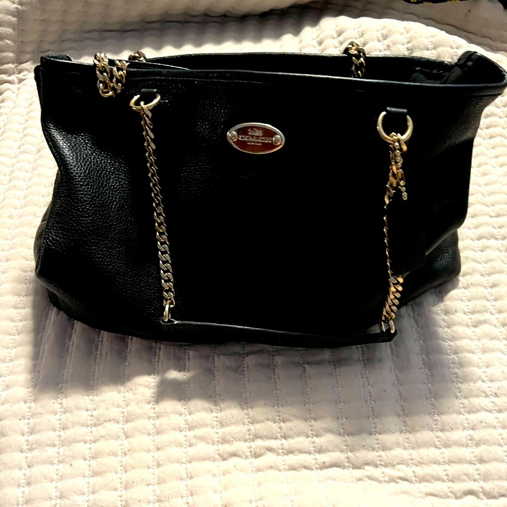 Black leather Coach bag with gold hardware.